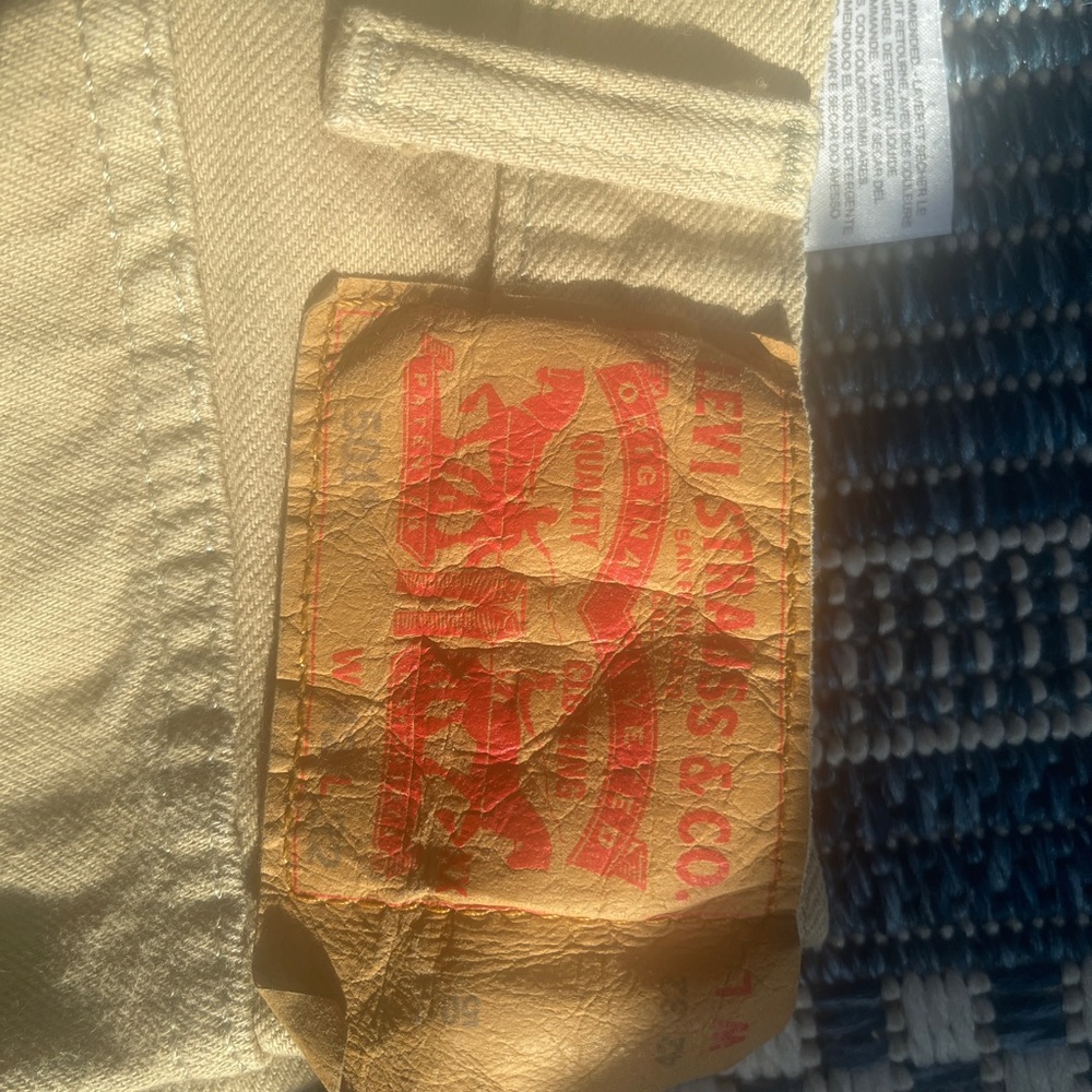 Means 501 Levis tan in color no rips or major wear. 42/32
